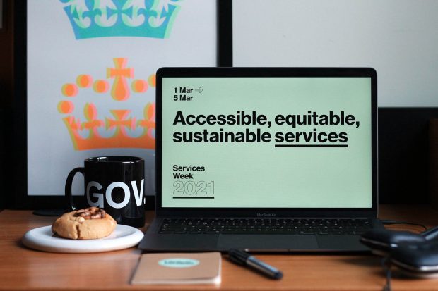 A computer on a desk showing a Services Week 2021 screen saying: Accessible, equitable, sustainable services