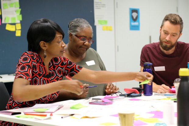 Three people mapping a service in government service design training