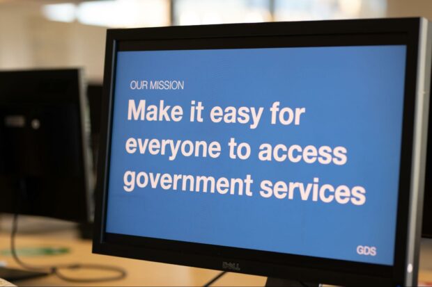 Computer monitor with presentation slide on the screen which reads ‘Our mission. Make it easy for everyone to access government services’