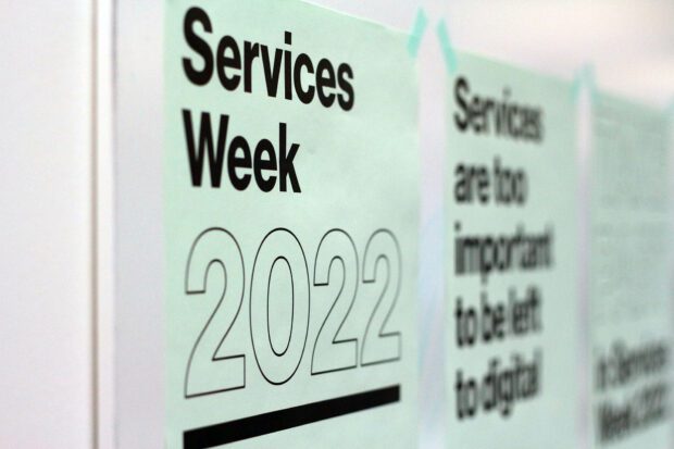 Posters on a wall promoting Services Week 2022
